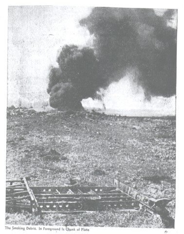 Newspaper photograph of the smoking wreckage